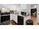 Well-lit kitchen featuring white cabinets, stainless steel appliances, and granite countertops at 1824 Vintage Rd, Raleigh, NC 27610