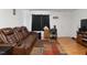 Comfortable living room features a leather sofa, modern furniture, and a neutral color palette at 1824 Vintage Rd, Raleigh, NC 27610