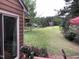 Beautiful backyard with a view of the pond and landscaped flower boxes on the home's wooden deck at 186 St. Andrews Ln, Chapel Hill, NC 27517