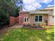 Beautiful backyard with a patio, garden beds, and lush green grass for outdoor enjoyment at 186 St. Andrews Ln, Chapel Hill, NC 27517