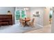 Inviting dining room with natural light, elegant piano, and easy access to the kitchen at 186 St. Andrews Ln, Chapel Hill, NC 27517