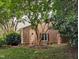 Charming home exterior with mature tree and landscaped yard at 186 St. Andrews Ln, Chapel Hill, NC 27517