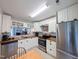 Bright kitchen with stainless appliances, white cabinetry, and breakfast area at 186 St. Andrews Ln, Chapel Hill, NC 27517