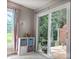 Cozy sunroom with sliding glass doors leading to a deck and plenty of natural light at 186 St. Andrews Ln, Chapel Hill, NC 27517