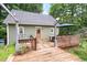 The wooden back deck has lattice railings and a partially-shaded area for outdoor dining and relaxation at 1869 Brevard Rd, Graham, NC 27253