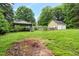 Large backyard features a metal carport and a garage with two bays at 1869 Brevard Rd, Graham, NC 27253