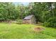 A spacious backyard features a home, a deck, and mature trees at 1869 Brevard Rd, Graham, NC 27253