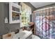 Neutral toned bathroom with a grey paint and quartz countertop atop a dark vanity and an open shelved storage piece at 1869 Brevard Rd, Graham, NC 27253