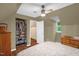 Angled bedroom with a closet, hardwood floors, a ceiling fan, and a window illuminating the space at 1869 Brevard Rd, Graham, NC 27253