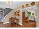 Dining area adjacent to living room featuring hardwood floors and natural light at 1869 Brevard Rd, Graham, NC 27253