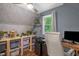 Office space with hardwood floors, wallpapered wall, shelving, storage bins, a desk, and a window illuminating the space at 1869 Brevard Rd, Graham, NC 27253