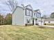 Two-story home with gray siding, a two-car garage, and a green lawn at 205 Swift Park Dr, Zebulon, NC 27597