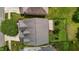 Aerial view of a home showcasing the roof, backyard with a patio area, and surrounding landscaping at 2067 Glenkirk Dr, Burlington, NC 27215