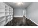 Minimalist bedroom with gray walls, tile floors, and a built-in bookcase at 2067 Glenkirk Dr, Burlington, NC 27215