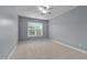 Bright bedroom with neutral carpet, ceiling fan, and a window offering natural light at 2067 Glenkirk Dr, Burlington, NC 27215