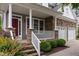Charming home featuring a stone facade, welcoming porch with columns, and a well-manicured front yard at 2067 Glenkirk Dr, Burlington, NC 27215
