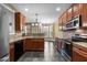 Modern kitchen featuring tile floors, wood cabinets, and stainless steel appliances at 2067 Glenkirk Dr, Burlington, NC 27215