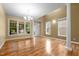 Bright dining room featuring hardwood floors, modern chandelier, large windows, and elegant decor at 2067 Glenkirk Dr, Burlington, NC 27215