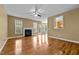 Bright living room featuring a fireplace, hardwood floors, and a ceiling fan at 2067 Glenkirk Dr, Burlington, NC 27215
