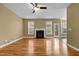 Spacious living room featuring a fireplace, ceiling fan, hardwood floors, and neutral-toned walls at 2067 Glenkirk Dr, Burlington, NC 27215
