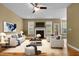 Spacious living room with a fireplace, ceiling fan, neutral-colored furniture, and ample natural light at 2067 Glenkirk Dr, Burlington, NC 27215