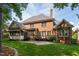 Brick home exterior featuring a patio and well-maintained lawn and garden at 209 Bailey Ridge Dr, Morrisville, NC 27560