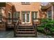 Rear view of home featuring a wooden deck and stone patio at 209 Bailey Ridge Dr, Morrisville, NC 27560