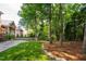 Well-manicured backyard with lush green lawn and mature trees at 209 Bailey Ridge Dr, Morrisville, NC 27560