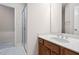 Well-lit bathroom with wood cabinets, neutral walls, a glass shower, and neutral tile flooring at 209 Bailey Ridge Dr, Morrisville, NC 27560