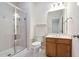 Bright bathroom featuring glass shower, white toilet, and wood cabinets at 209 Bailey Ridge Dr, Morrisville, NC 27560