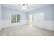 Bedroom featuring wainscoting, plush carpet, closet, and ceiling fan at 209 Bailey Ridge Dr, Morrisville, NC 27560