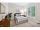 Comfortable bedroom with neutral tones, a large window, and carpet flooring at 209 Bailey Ridge Dr, Morrisville, NC 27560