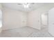 Neutral bedroom with ceiling fan, carpeted floor, double doors, and bright window at 209 Bailey Ridge Dr, Morrisville, NC 27560