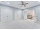 Spacious bedroom with multiple closets, carpet, and staircase access at 209 Bailey Ridge Dr, Morrisville, NC 27560