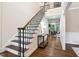 Entryway features hardwood floors, a staircase, and a view into the living room at 209 Bailey Ridge Dr, Morrisville, NC 27560