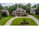 Beautiful two-story brick home with mature trees and a circular driveway at 209 Bailey Ridge Dr, Morrisville, NC 27560