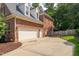 Large brick home featuring a three-car garage and spacious driveway at 209 Bailey Ridge Dr, Morrisville, NC 27560