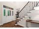 Elegant foyer with hardwood floors, staircase with iron railings, and a view of the study at 209 Bailey Ridge Dr, Morrisville, NC 27560
