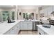 Bright kitchen with white cabinets, quartz countertops, stainless steel appliances and breakfast nook overlooking backyard at 209 Bailey Ridge Dr, Morrisville, NC 27560