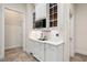 Kitchen with white cabinets, quartz countertops, stainless steel microwave and hallway to a laundry at 209 Bailey Ridge Dr, Morrisville, NC 27560