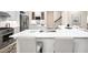 Island with quartz countertops, stainless steel sink and faucet with seating for casual dining in open kitchen at 209 Bailey Ridge Dr, Morrisville, NC 27560