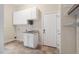 Functional laundry room with sink, cabinets, and ample storage space at 209 Bailey Ridge Dr, Morrisville, NC 27560