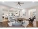 Open-concept living room with hardwood floors, cozy seating and a kitchen visible through arched doorway at 209 Bailey Ridge Dr, Morrisville, NC 27560