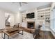Inviting living room with a cozy fireplace and built-in bookshelves for a relaxing atmosphere at 209 Bailey Ridge Dr, Morrisville, NC 27560