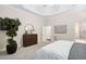 Main bedroom showcasing a decorative tray ceiling, dresser, and a view into the en suite bath at 209 Bailey Ridge Dr, Morrisville, NC 27560