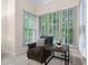 Bedroom sitting area with a comfortable chair, accent table, and bright natural light at 209 Bailey Ridge Dr, Morrisville, NC 27560