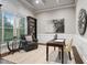 Cozy study with built-in shelves, wainscoting, and a large arched window at 209 Bailey Ridge Dr, Morrisville, NC 27560