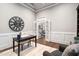 Well-appointed study with a large clock, a writing desk, and French doors at 209 Bailey Ridge Dr, Morrisville, NC 27560