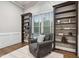 Bright study featuring built-in bookshelves, a comfortable armchair and large window at 209 Bailey Ridge Dr, Morrisville, NC 27560