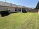 Grassy backyard with a garden featuring hydrangeas, plus a screened in porch at 2535 Kinglass Dr, Fuquay Varina, NC 27526